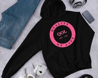 May include: Black hooded sweatshirt with a pink circle graphic that says "Quality of Life" and "QOL Est. 1993".