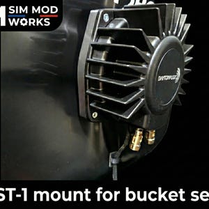 May include: A black BST-1 mount for a bucket seat. The mount features a Dayton Audio logo and gold-colored connectors. The image also displays the Sim Mod Works logo.