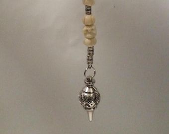 Unique pendulum, skull beads and silver color focal, 8" long. 123