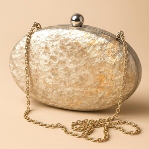 Woman Clutch Bag—Designer Bag, Handmade Bag, Statement-Fashion, Fancy Bags for Women, Women's Small Bag Clutch, Gift Her!. Bridal Clutch Bag—Mother of Peral style bag This oval-shaped hard shell clutch is not just a bag; it's a conversation starter meticulously designed to echo the breathtaking textures of the moon's landscape. Its pristine white exterior glimmers softly, capturing the light and reflecting it in a way that draws attention without saying a word. Handmade in USA. Mothers day gift
