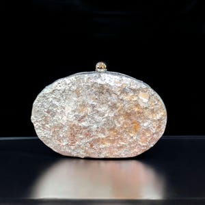 Woman Clutch Bag—Designer Bag, Handmade Bag, Statement-Fashion, Fancy Bags for Women, Women's Small Bag Clutch, Gift Her!. Bridal Clutch Bag—Mother of Peral style bag This oval-shaped hard shell clutch is not just a bag; it's a conversation starter meticulously designed to echo the breathtaking textures of the moon's landscape. Its pristine white exterior glimmers softly, capturing the light and reflecting it in a way that draws attention without saying a word. Handmade in USA. Mothers day gift