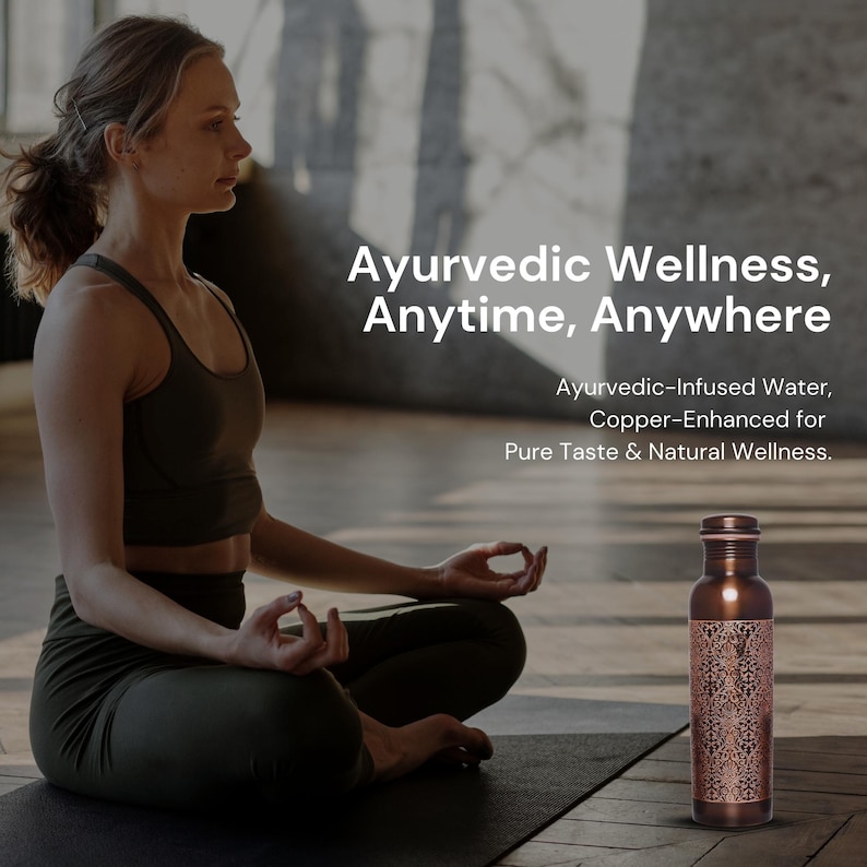 May include: A woman sits in a yoga pose on a mat with a copper water bottle on the floor in front of her. The bottle has an intricate design and is labeled "Ayurvedic Wellness, Anytime, Anywhere. Ayurvedic-Infused Water, Copper-Enhanced for Pure Taste & Natural Wellness."