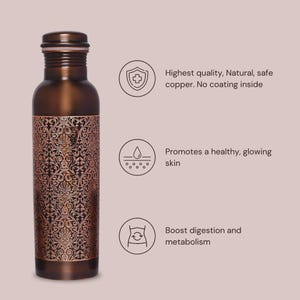 May include: A copper water bottle with an intricate floral design. The bottle is made of pure copper and has no coating inside. The bottle is said to promote healthy skin, boost digestion, and improve metabolism.