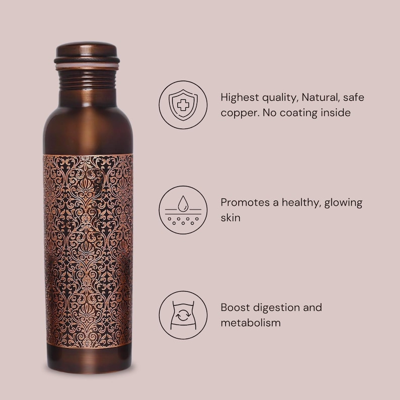 May include: A copper water bottle with an intricate floral design. The bottle is made of pure copper and has no coating inside. The bottle is said to promote healthy skin, boost digestion, and improve metabolism.