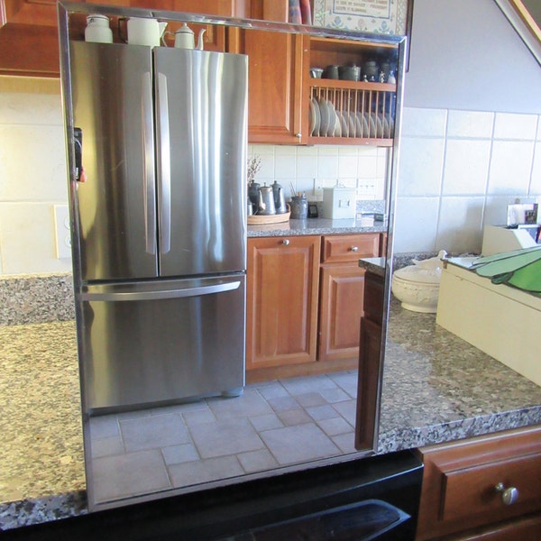 Nice mid century metal cabinet with interior glass shelves, mirror, hinged door with magnet closure