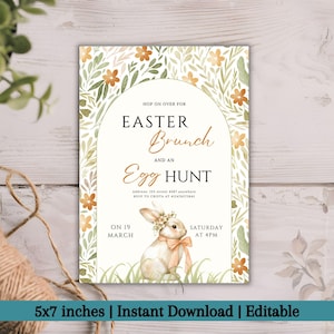 May include: An Easter brunch and egg hunt invitation with a floral design. The invitation features a bunny illustration with a floral crown and ribbon. The text includes the date, time, and address. The invitation is 12.7 x 17.8 cm.