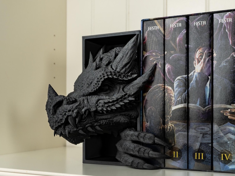 May include: Black dragon bookends with a detailed, textured design. The dragon's head is peeking out from behind a set of four books with the word "FESTA" on the spines. The books are numbered II, III, and IV.