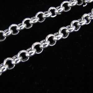 May include: A silver chain necklace with a delicate, round link design.