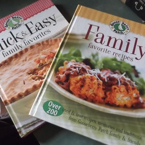 May include: Two Gooseberry Patch cookbooks, one titled "Quick & Easy family favorites" with a pie on the cover, and the other titled "Family favorite recipes" with a casserole on the cover.