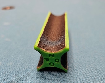 May include: A green and black pool cue tip shaper with the text "200" printed on the side.