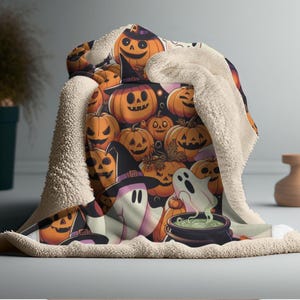 May include: A Halloween-themed blanket featuring a pattern of smiling jack-o'-lanterns, ghosts, and a witch's cauldron. The blanket has a soft, cream-colored sherpa lining. The design includes orange, black, purple, and white elements, perfect for seasonal decor.