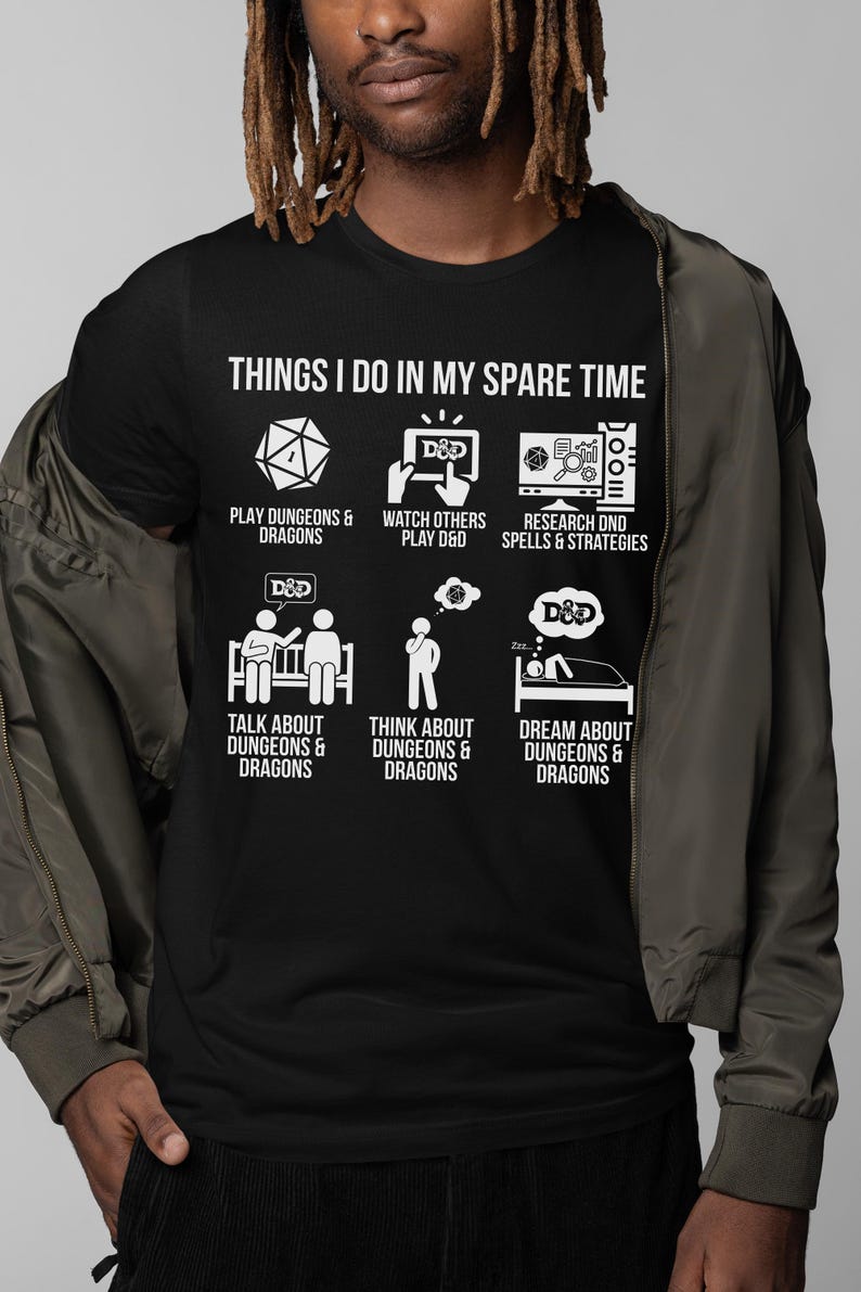 May include: Black t-shirt with white graphic text and illustrations about Dungeons & Dragons. The text reads "THINGS I DO IN MY SPARE TIME" with icons for playing, watching, researching, talking, thinking, and dreaming about D&D.