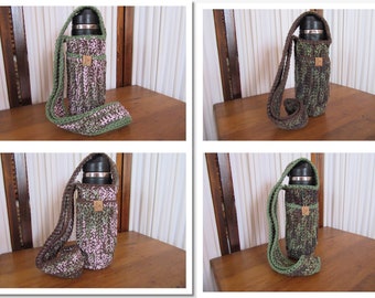 May include: A crocheted water bottle holder with a matching strap. The holder is a mix of brown, green, and pink yarn. A small wooden tag is attached to the front. The strap is green and brown.