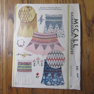 May include: A McCall's Kaumagraph Transfer pattern for smocking borders in two sizes with small sprays. The pattern is for yellow or blue fabric and is 25 cents.