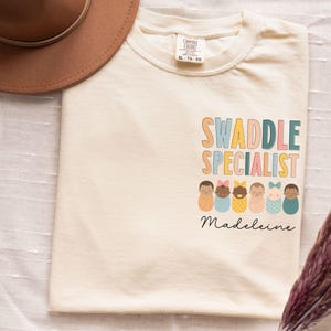 Personalized Swaddle Specialist Shirt Comfort Colors Custom Labor And Delivery Nicu Nurse Sweatshirt Mother Baby Neonatal Icu Nurse Shirt