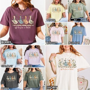 May include: Various colors of t-shirts with a whimsical illustration of geese and the text "off to fix a latch." The shirts come in berry, banana, bay, blossom, blue jean, chambray, orchid, pepper, moss, and ivory.