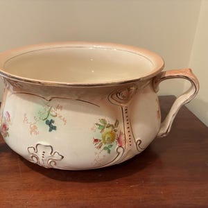 May include: A set of three ceramic mugs with a speckled, matte finish. The mugs are in shades of cream, light gray, and dark gray. Each mug has a simple, minimalist design, perfect for coffee or tea.