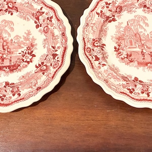 May include: A white ceramic mug with a black handle and the text "But First, Coffee" in a black, handwritten-style font. The mug is on a white surface.