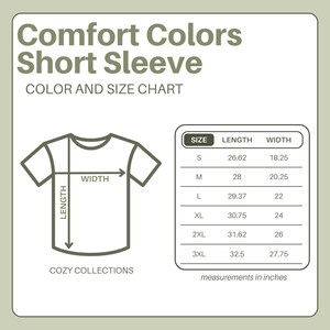 May include: A chart showing the size and measurements of a Comfort Colors short sleeve t-shirt. The chart includes length and width measurements in inches for sizes S, M, L, XL, 2XL, and 3XL. The text "COZY COLLECTIONS" is also present.
