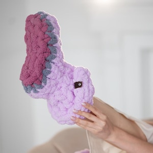 May include: Purple and pink fuzzy knitted slippers with a gray trim.