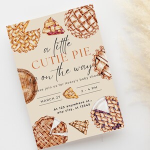 May include: A baby shower invitation with a beige background and the text "A little cutie pie is on the way". The invitation is decorated with illustrations of various pies, including a blueberry pie, a cherry pie, and a pumpkin pie.