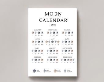 May include: A white 2026 Moon Calendar print. The calendar displays the phases of the moon for each month, with the month names and dates in black text. The moon phases are illustrated in watercolor style.