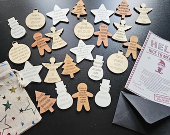 May include: A collection of wooden Christmas ornaments in various shapes, including stars, angels, and trees, with engraved text. A small bag with star designs and a card with the text "Hello, Nice to Meet You" are also present.