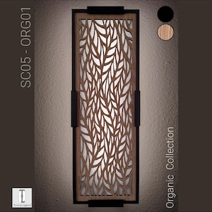 May include: Rectangular wooden wall sconce with a leaf-like cutout design. The sconce has a black frame and handles, with the text "SC05 - ORG01" and "Organic Collection" visible. The image also shows color options: black and wood.