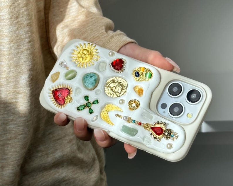 a person holding a cell phone with a bunch of buttons on it