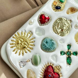 a white tray with a bunch of different jewels on it