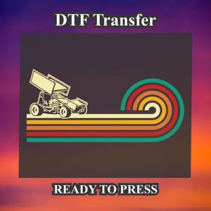 May include: A digital transfer design featuring a vintage-style illustration of a race car driving across a rainbow stripe background. The text "DTF Transfer" and "READY TO PRESS" is included in the design.