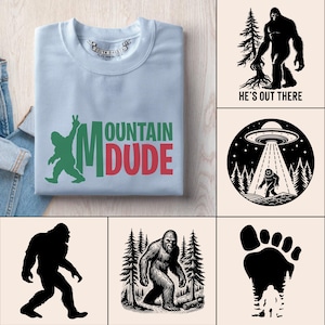 May include: A pale blue sweatshirt featuring the text "MOUNTAIN DUDE" in green and red, and a green Bigfoot graphic. The image also includes several Bigfoot-themed graphic designs in black and white.