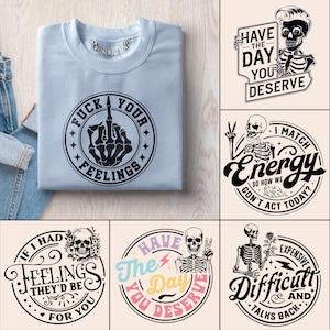 May include: A light blue sweatshirt with the text "FUCK YOUR FEELINGS" and a graphic of a skeleton hand giving the middle finger. Additional graphics include skeleton illustrations with text: "HAVE THE DAY YOU DESERVE", "I MATCH ENERGY", and "EXPENSIVE DIFFICULT AND TALKS BACK".