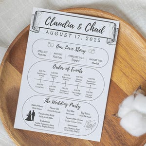 May include: A wedding timeline and party details card with the names "Claudia & Chad" and the date "August 17, 2025" printed in black on white paper. The card includes sections for the couple's love story, order of events, and wedding party.