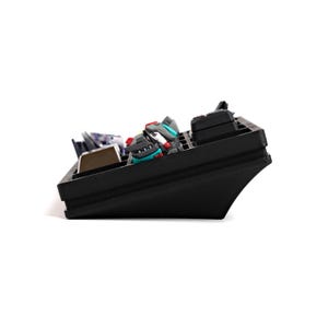 May include: A black keyboard with several small, colorful sneaker-shaped keycaps. The keycaps are gray, red, and teal. The keyboard is angled, and the keycaps are arranged in rows.