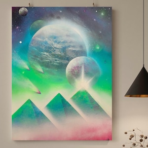 May include: A colorful abstract painting with a green, blue, and pink color scheme. The painting depicts a celestial scene with planets, stars, and comets. There are three green pyramids in the foreground.