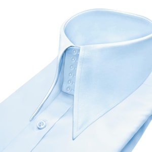 May include: A light blue dress shirt, close-up view. The shirt has a high, pointed collar and a series of small buttons. The fabric is smooth and crisp, with a single button visible on the placket.