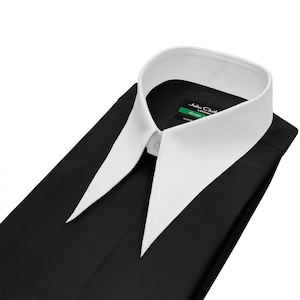 May include: A black dress shirt with a white collar. The shirt is folded neatly, with the collar and the top of the shirt visible. The collar is a classic style, with long, pointed tips. The shirt has a tag that reads "John Cloth London Green".