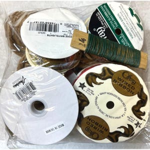 May include: A clear plastic bag filled with various spools of ribbon and floral wire. The spools are white, gold, and red, with printed labels. The floral wire is green and wrapped around a wooden spool. The image includes the text "WIRED RIBBON".