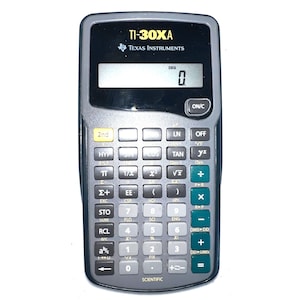 May include: A TI-30XA scientific calculator by Texas Instruments. The calculator has a black and gray body with numerous buttons for scientific functions. The display shows the number zero. The calculator is designed for educational and professional use.