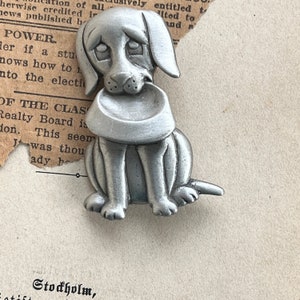 JJ puppy pewter holding his dinner bowl.