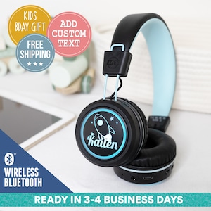 May include: Black wireless Bluetooth headphones with a light blue headband and earcups. The headphones have a light blue and black rocket design with the name "Kailen" on the earcup.