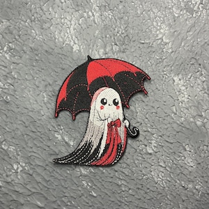 May include: Embroidered iron-on patch of a ghost holding a red and black umbrella. The ghost has a friendly face with big eyes and a small smile.