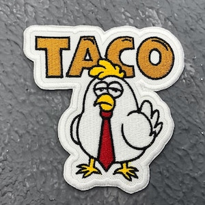 May include: Embroidered patch with the word "TACO" in gold lettering above a cartoon chicken wearing a red tie. The chicken has yellow hair and feet, a white body, and a grumpy expression.