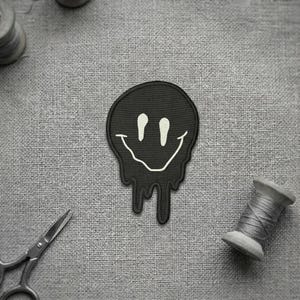 Preppy meltin smiley face embroidered patch. Smiley face embroidered patch.