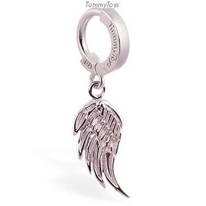 May include: Silver hoop earring with a dangling silver angel wing charm. The hoop is hinged and has a click closure. The wing charm has a detailed design.