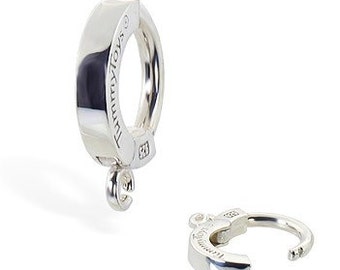 May include: Silver hinged hoop earring with a small charm hanging from it. The charm has the word "TummyToys" engraved on it.