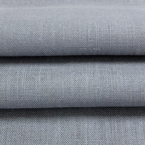 May include: Close-up of a light gray fabric with a woven texture. The fabric is folded in thirds, showing the texture from different angles.