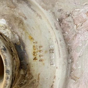 May include: Close-up of a white ceramic object with the text "K 6188101" and "A 8068 7 35304" printed on it.