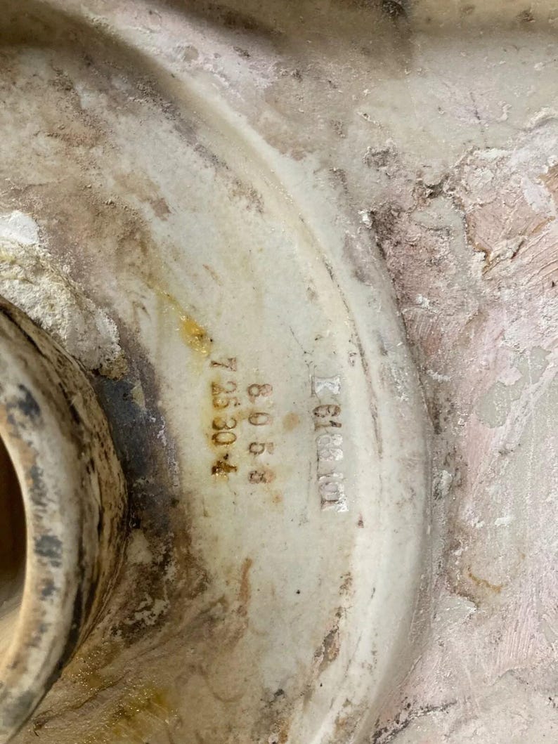 May include: Close-up of a white ceramic object with the text "K 6188101" and "A 8068 7 35304" printed on it.
